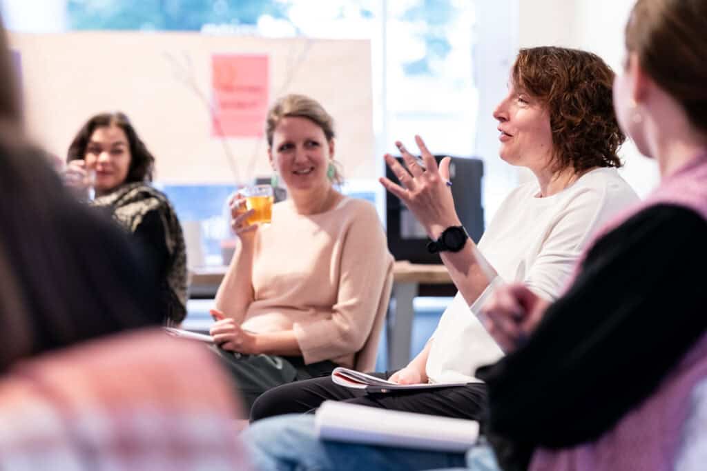 Women discuss Embodied Leadership during a somatic coaching retreat.